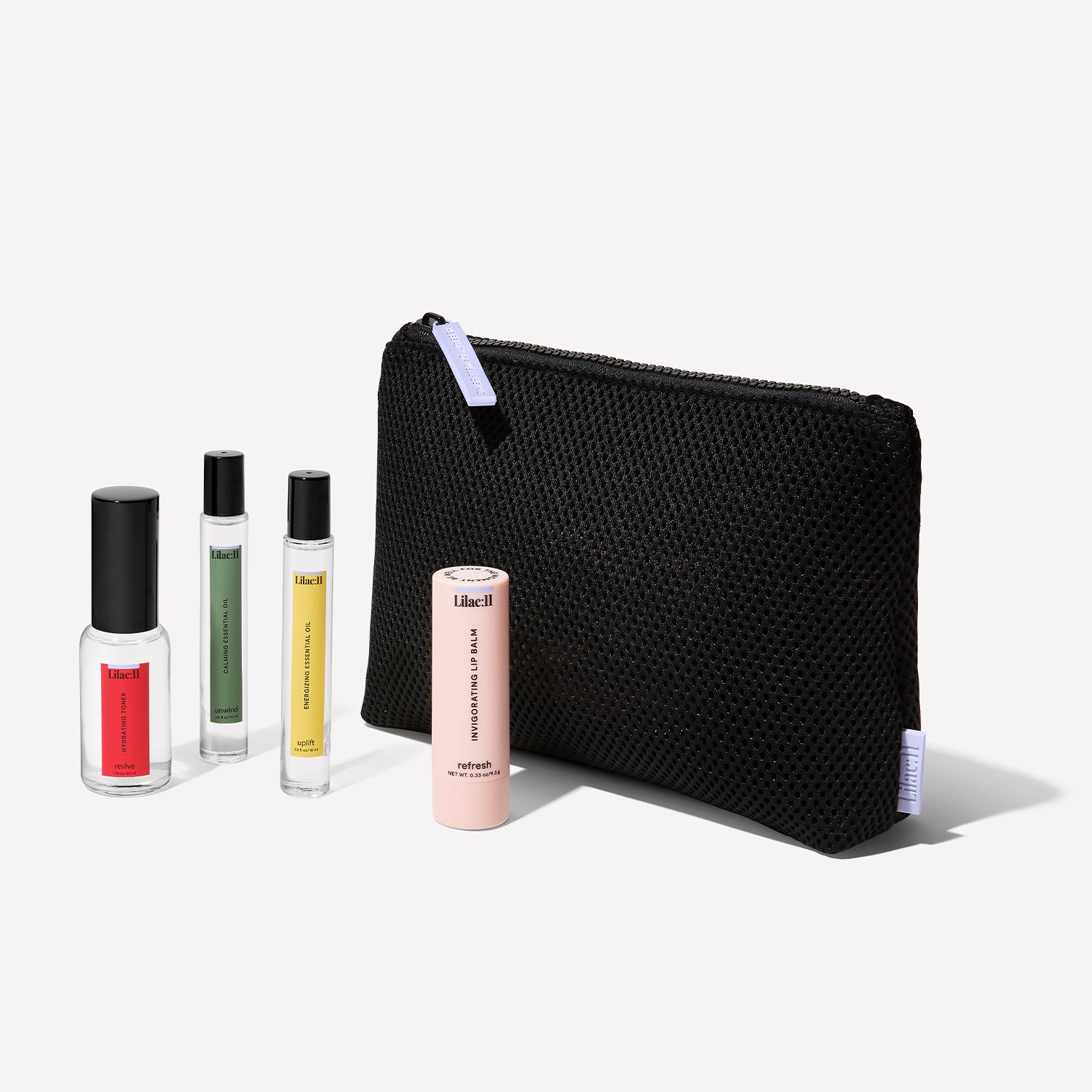 The Be Well for the Moment Kit with the hydrating toner, calming essential oil, energizing essential oil, invigorating lip balm and black mesh bag.