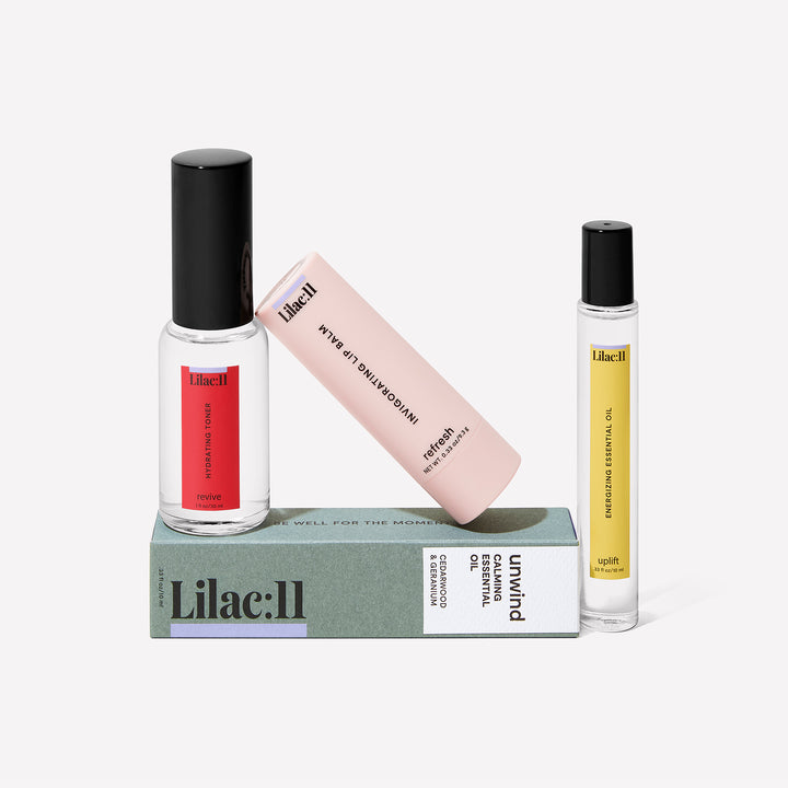 The Be Well for the Moment Kit with the hydrating toner, calming essential oil, energizing essential oil, invigorating lip balm and black mesh bag.